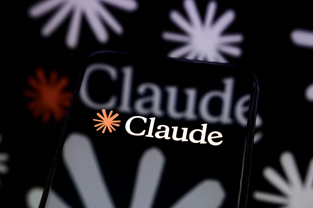 Claude AI logo on smartphone screen with reflections